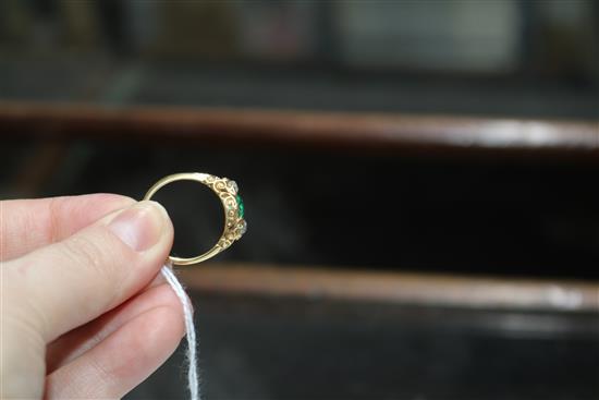 A late Victorian yellow metal, emerald and diamond three stone ring, size Q.